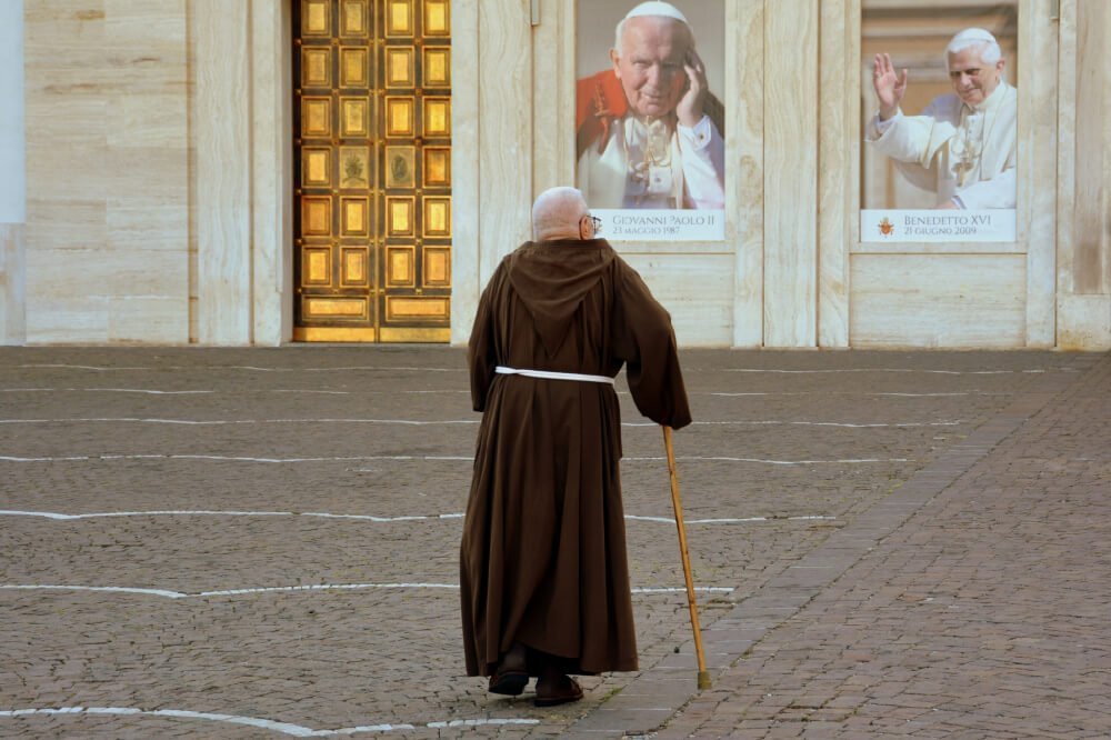 a friar looking at images of popes